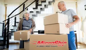 An elderly couple packing small boxes ready for moving. Hire small move specialists to help you.