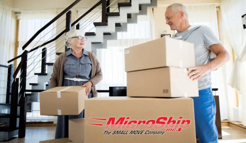 An elderly couple packing small boxes ready for moving. Hire small move specialists to help you.