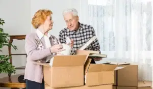 Two elderly couple packing their things. Find personalized senior moving services in your area.